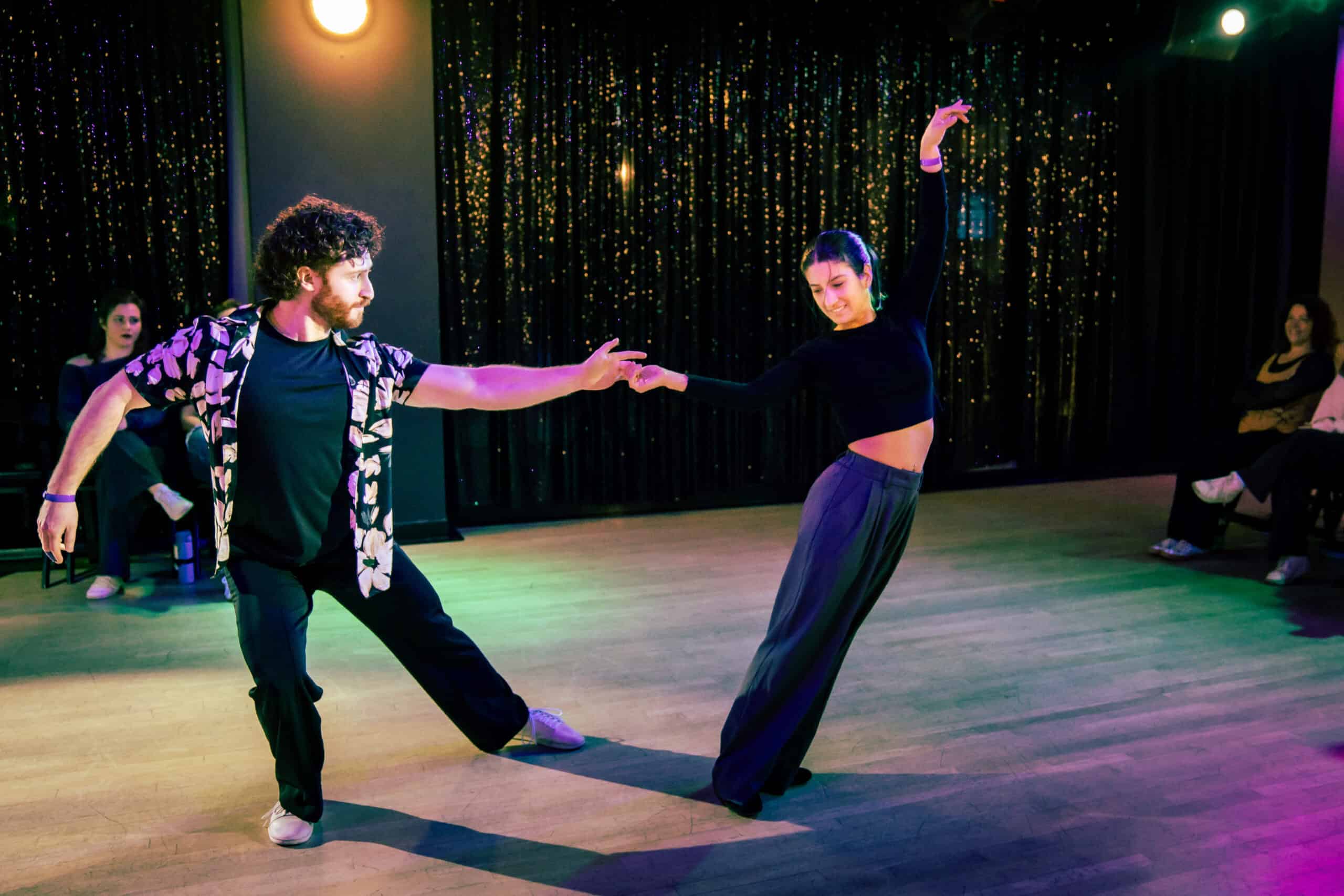 Two dancers working on technique on the workshop floor